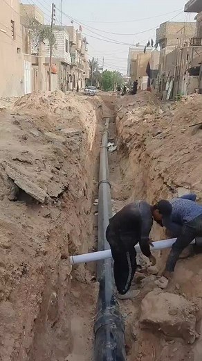 Laying PVC Pipe: Construction Work in Residential Area
