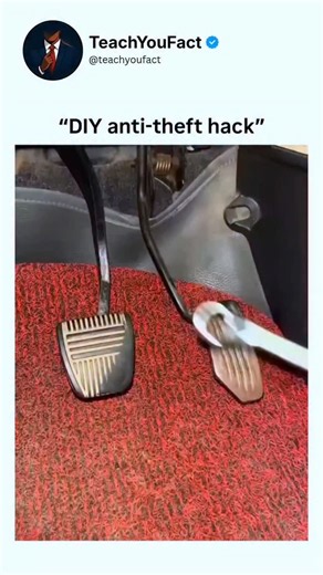 teachyoufact on Instagram: "The video demonstrates a makeshift anti-theft device for a manual transmission car, focusing on the foot pedals in the driver's footwell against a red carpeted floor. A hand enters the frame holding a metal bar with open U-shaped hooks on both ends and a central padlock mechanism. The person attaches one hook over the clutch pedal arm and the other over the brake pedal arm, connecting the two pedals horizontally. They then insert a key into the padlock, twist it to lo