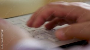 Hands typing on a keyboard in a close-up shot