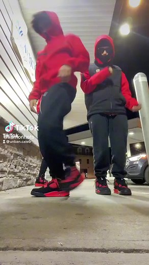 Coordinated Dance Routine in Red Hoodies at Night