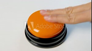 Young woman pushing orange button with a finger and palm of her hand. Press a round glossy button close up. Activation, launching something. Turn on and off.