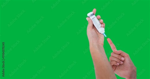 Hands using lancet on finger for checking blood sugar level against black background