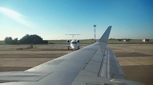 View of sky from aircraft windows while driving on the runway