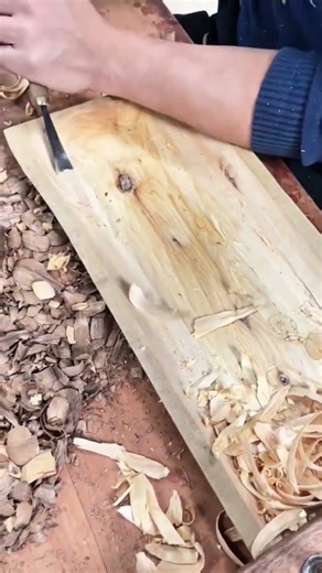 smoothing out wood surfaces using a hand chisel for traditional woodworking and carving activities