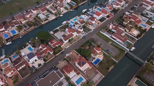 Empuriabrava Costa Brava Spain forward low drone footage over the largest residential marina in Europe to where the canals meet the land showing incredible canalside houses and boats berthed