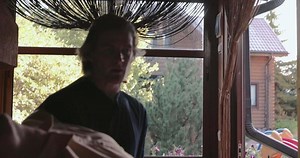 A man carrying a woman in his arms. Stock. A young man carrying an unconscious girl into the house.