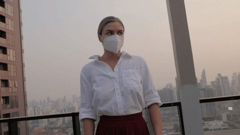 clip-3988714149-woman-removing-face-mask-breathing-fresh-air