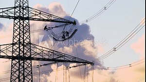 High voltage pylons and power lines are maintained by technicians