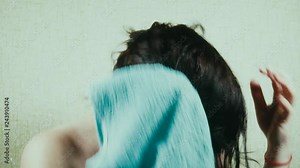 Woman drying her hair with a towel
