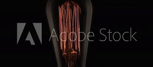 lightbulb turning on, moving filaments and illustrating the concept of thinking and having original ideas, finding a great source of inspiration