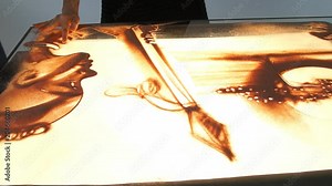 Drawing with sand. Drawing sand on a white screen. Sand Artist. Hands draws