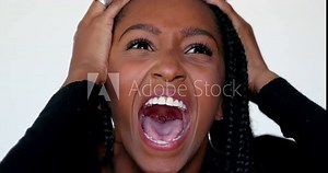 Anxious African girl emotional reaction, black teen woman hitting own face in despair, yelling and screaming