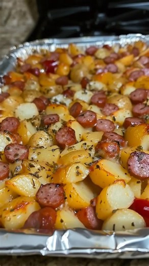 Dish Name: Roasted Sausage and Potatoes Ingredients - 400 g smoked sausage (sliced) - 500 g baby potatoes (halved) - 1 cup bell peppers (chopped) - 1 small onion (chopped) - 3 tbsp olive oil - 1 tsp garlic powder - 1 tsp dried oregano - ½ tsp paprika - ½ tsp salt - ½ tsp black pepper - 1 tbsp chopped parsley Recipe 1. Preheat the oven to 200°C (400°F). 2. In a large bowl combine baby potatoes, sausage slices, bell peppers, and onion. 3. Add olive oil, garlic powder, oregano, paprika, salt, and b