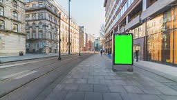A modern digital advertising billboard with a green screen display,...