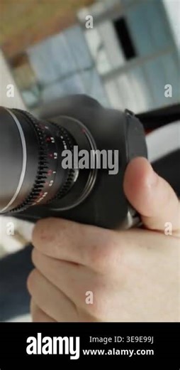 This video highlights photography, featuring closeups of a person using a camera, showcasing their hands and focused expression as they prepare to shoot Stock Video Footage - Alamy