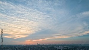 Sunset and cirrus clouds from thunderstorms over the city and river time lapse majestic sunset landscape.