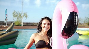 Woman in bikini enjoying vacations in the swimming pool - Free Stock Video