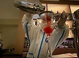 Cocktails and waiters in hazmat suits mingle in the Beijing Olympics bubble
