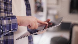 slow motion scen man hand press on digital tablet to turn on function technology for using home automation application to looking inside home and property for innovation future concept