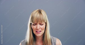 Face of woman crying in studio for sad emoji, trauma and broken heart on grey background. Heartbreak, depression and emotional pain of crisis, grief counselling or tears for mourning, loss or mistake