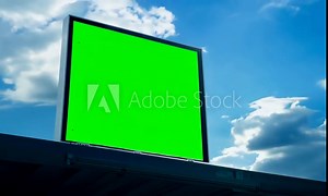 Blank billboard green screen on a clear blue sky, an empty canvas for outdoor advertising