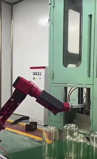 Pick and place manipulator robot works with blow molding production