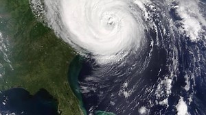 Download Satellite view of a massive hurricane with a clear eye threatening the southeastern united states coast. for free