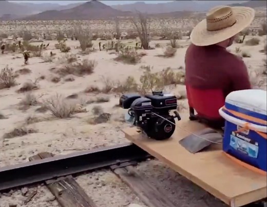 Watch: man rides DIY two-seater rail cart along deserted railroad tracks
