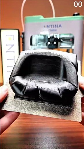 3D printer builds black lattice structure, layers stack with precise deposition