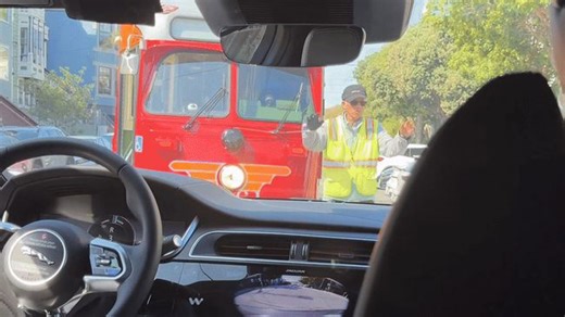 Couple Bemused as Their Waymo Blocks San Francisco Streetcar