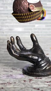 Giant chocolate ball vs. hand of God