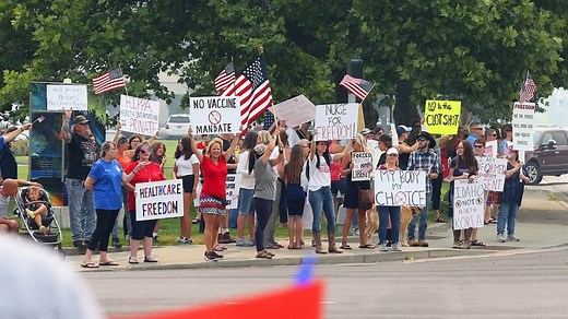 Protesters against health care vaccine mandates rally outside Kootenai Health