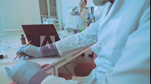 cinematic shoot of a scientist recording data in a lab, emphasizing research, experimentation, and collaboration in science