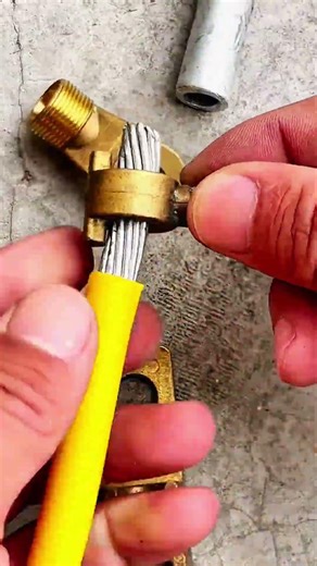Thick yellow insulated cable with brass terminal connectors for electrical termination
