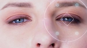 Close up shot of woman looking at camera with facial technology and retina scanning