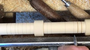 One of the things you have to do as a production turner is remember what the lines are marking and the most efficient order to work saving multiple tool changes. Note where there is a crisp edge I don’t plunge the v cut in one go as this gives a slight burr so the turning would not be sharp. On a radius like a bead this doesn’t matter. These are long thin spindles so you get whip even with a steady so at one point I have to hand support to give the cleanest cut. | The woodturners