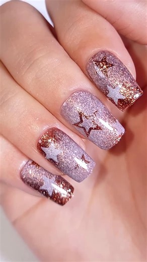 Nail art 💅 Manicure on Instagram: "@brightrainbownails ✨ Brown Gradient ✧ Starry Sparkle Nails ✨ 💡 The gradient from dark to light resembles the afterglow of a sunset, with tiny glitter particles gently shimmering in the light, adorned with stars. 💕 Sweetness + understated luxury = the perfect must-have for autumn and winter. 🙌Using @brightrainbownails: Bronze Bells - Matallic Glitter gel nail polish #44 🌈Follow @brightrainbownails to participate in the Black Friday event and win a nail art