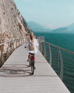 9.7K views · 495 reactions | Truly one of the most beautiful bike paths in the world! ✨ Cycle around Garda Lake, Italy's largest lake, on this "floating" cycle path that gives cyclists the impression that they're flying over water. Would you try cycling hands up here?   @backpackdiariez  Garda Lake, Italy  Stereoclip - Tramway | Beautiful Destinations | Facebook