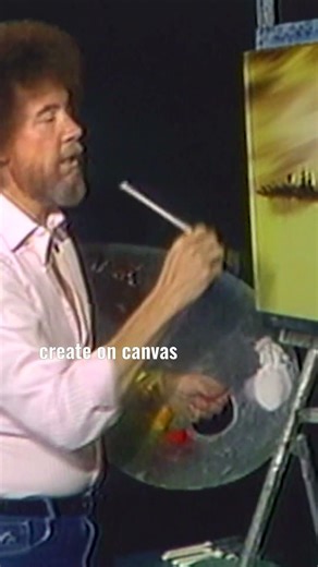 Bob Ross uses a fan brush to add branches to his evergreen trees