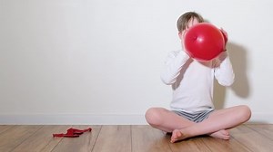 clip-1086735452-7-year-old-boy-playing-red-balloon