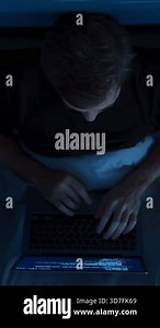 Overhead view of man using laptop for work in bed during late night hours. Programmer writing code in bed at night. Remote work, overwork or insomnia concept. vertical video