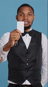 Vertical Video Hotel concierge presenting the room access key card after check in, providing luxury lodging and amenities at five star holiday resort. Reception personnel gives assistance to guests