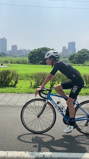 Cyclist on Blue Road Bicycle: Captivating Park Ride