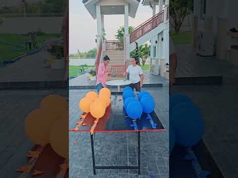 Grandma Lian and Grandma Pa set up a bottle to pop balloons for a prize.