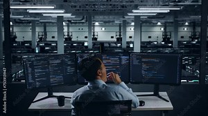 Back View Of Tired Asian Man Developer Yawning Before Sleeping While Write Code With Multiple Computer Screens In Data Center