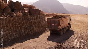 Viaduct construction work. Road construction work. Workers working in teams at the construction site. Earthmoving shed trucks. Construction worker. Excavator.
