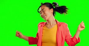 Woman, happy dance and freedom on green screen, background and studio for fun party celebration. Dancing, smile and asian model with excited energy to celebrate happiness, groovy music and winning