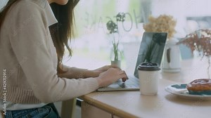 young attractive asian female wear casual cloth hand use smartphone and laptop device comminication social contact in cafe restaruant sit at counter next to big window daylight
