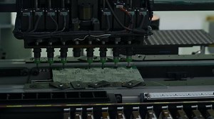 Automatic pick and place machine is installing components on circuit board. Creative. Electronic devices production industry.