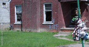 Dangerous neighborhood where someone was murdered and remembered with balloons and teddy bears. Ghetto memorial. Rest in peace